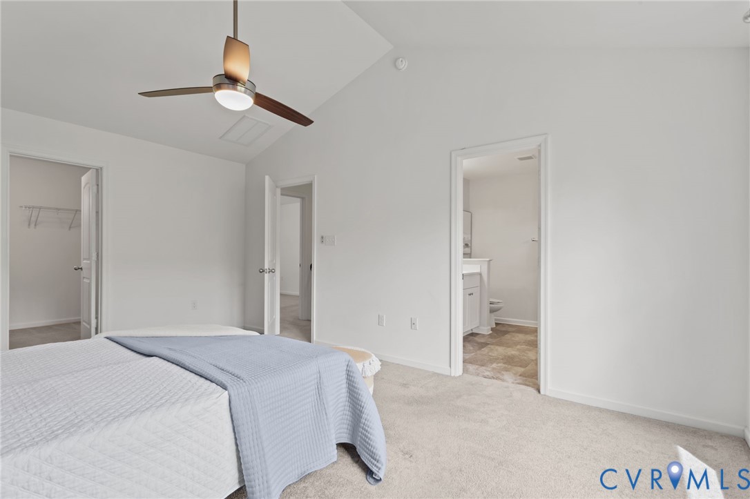 4237 Wells Ridge Court Chester, VA 23831 - Photo 29 of 47 a bedroom with a large bed and a chandelier