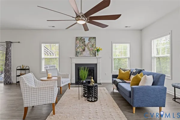 a living room with furniture fireplace and window