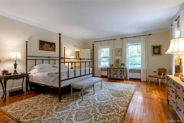 a bedroom with furniture and a wooden floor