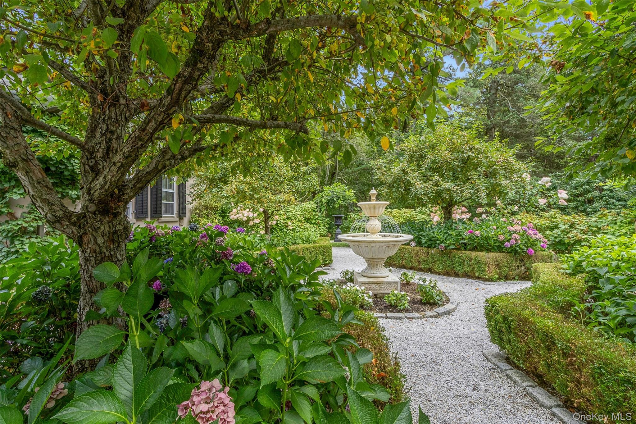 55 Mountain Farm Road Tuxedo Park, NY 10987 - Photo 29 of 42 a view of a garden with a fountain
