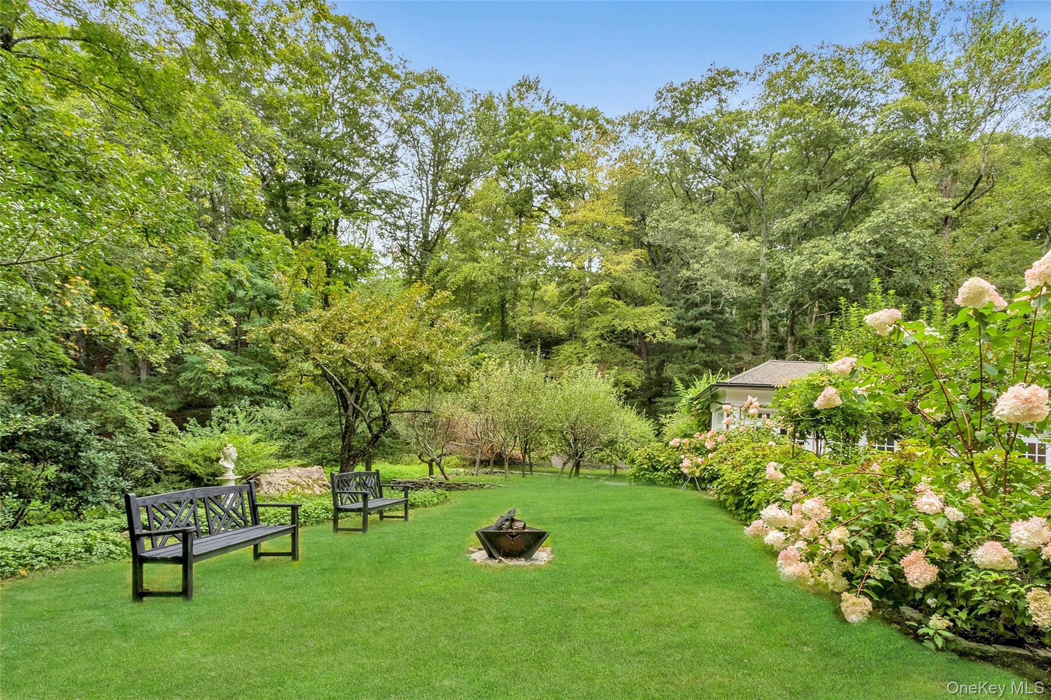55 Mountain Farm Road Tuxedo Park, NY 10987 - Photo 31 of 42 a garden with trees in front of it