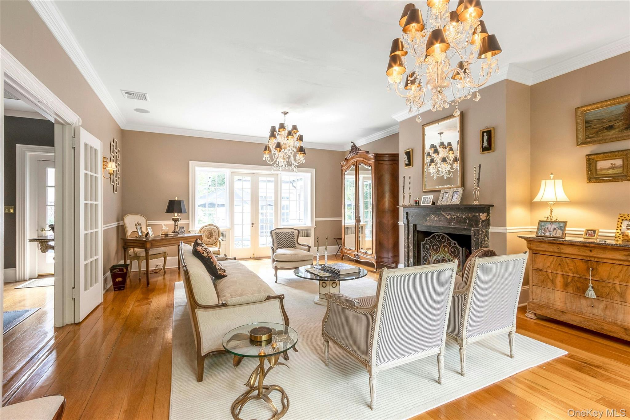55 Mountain Farm Road Tuxedo Park, NY 10987 - Photo 7 of 42 a living room with fireplace furniture and a chandelier