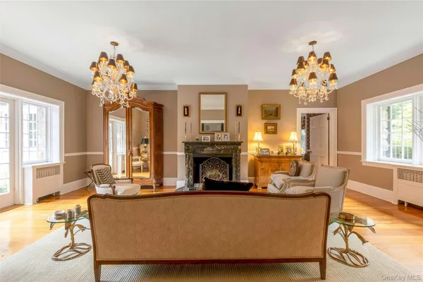 a living room with fireplace furniture and a chandelier