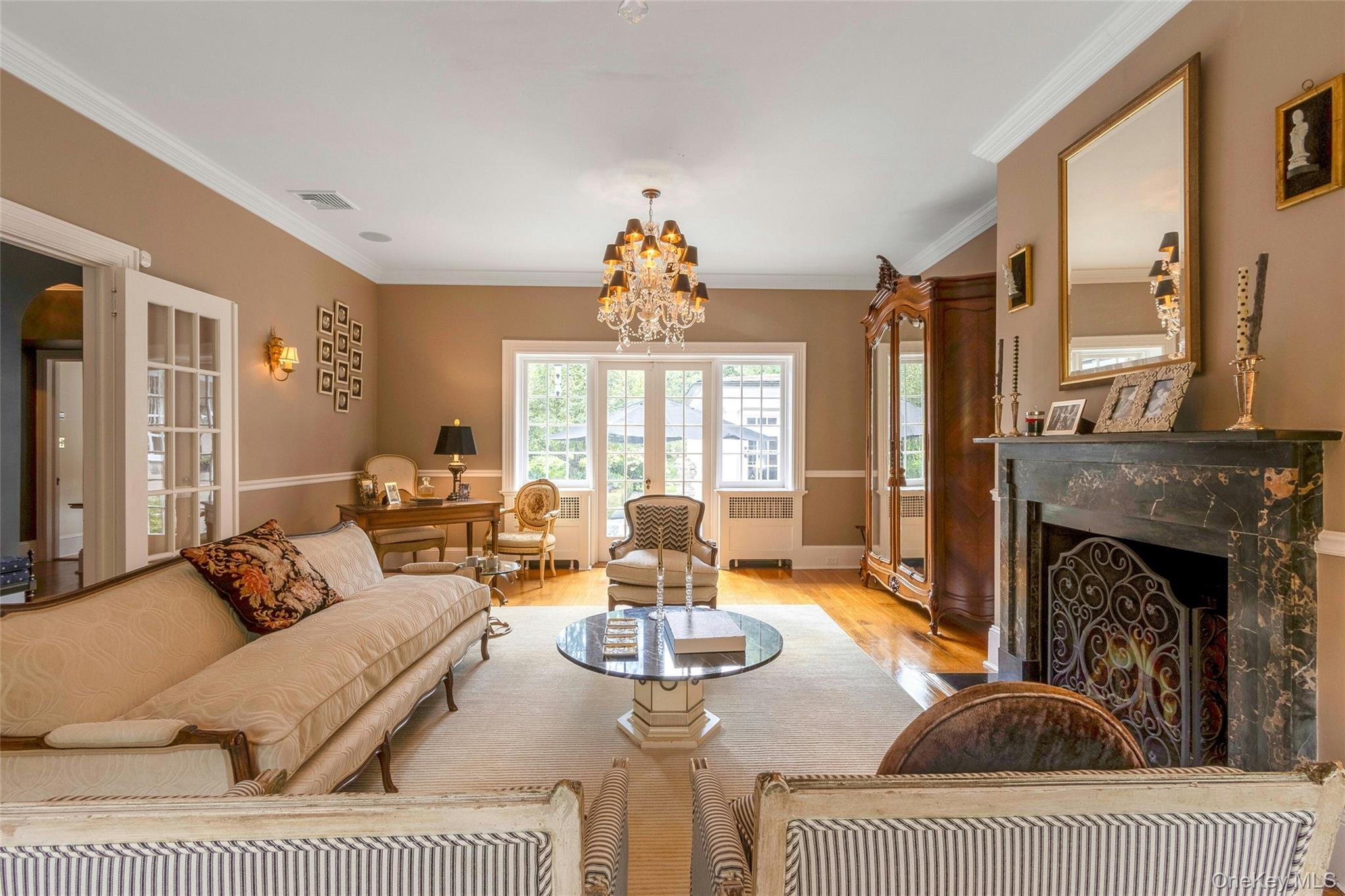 55 Mountain Farm Road Tuxedo Park, NY 10987 - Photo 8 of 42 a living room with furniture a fireplace and a chandelier