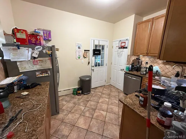 a kitchen with a refrigerator and a stove top oven