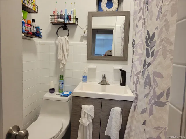 a bathroom with a sink toilet and mirror