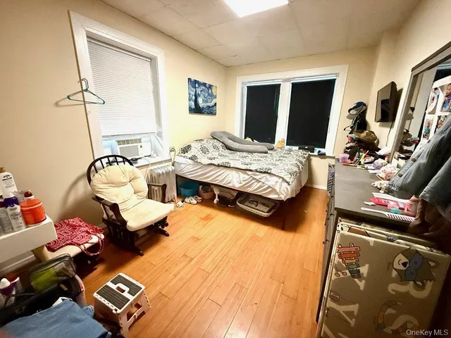 a bedroom with furniture and a flat screen tv