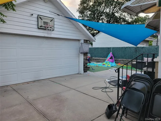 a view of a patio with table and chairs under an umbrella