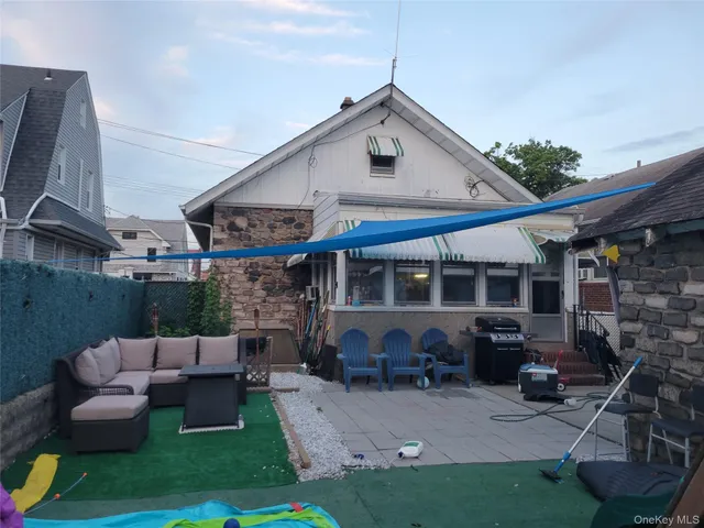 a view of a patio with table and chairs potted plants and a fireplace