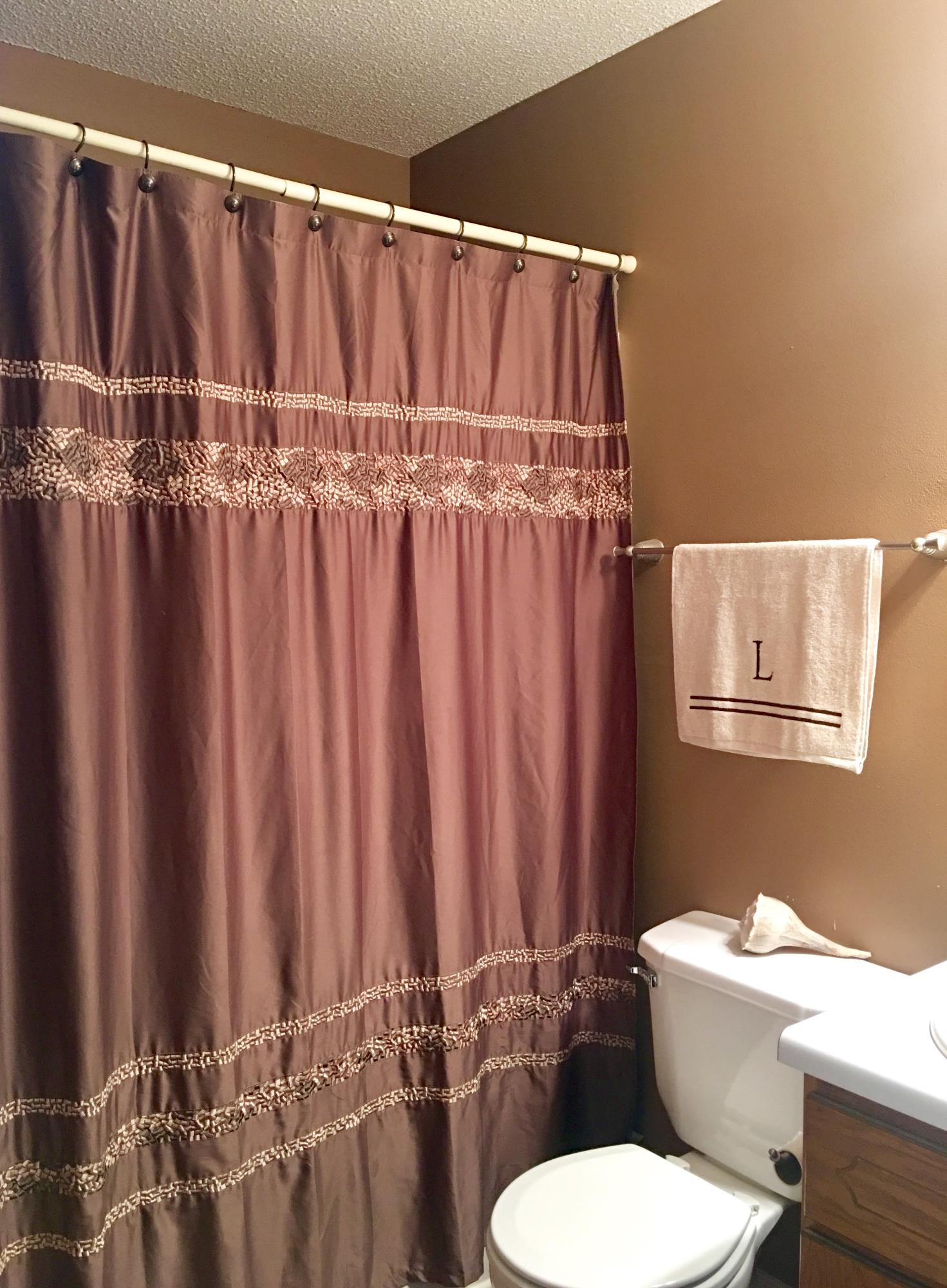 6231 Winstead Road Crestview, FL 32539 - Photo 14 of 22 a bathroom with a toilet and a shower curtain