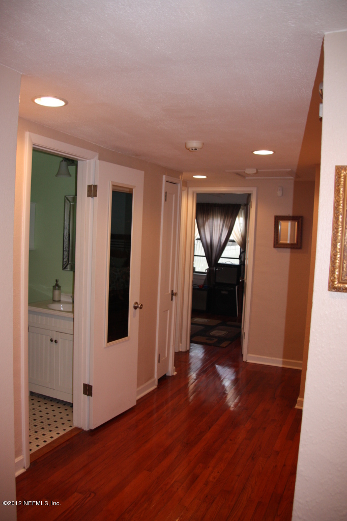 4732 Sunderland Road Jacksonville, FL 32210 - Photo 10 of 15 a view of a hallway with wooden floor and windows