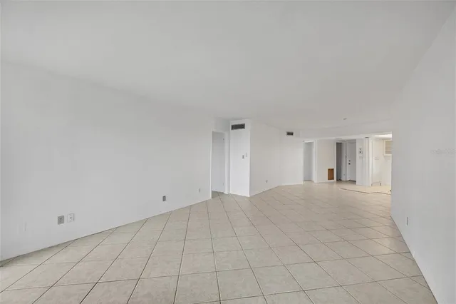 a view of an empty room with closet area