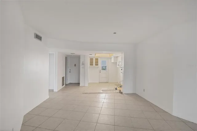 a view of an empty room with a fireplace