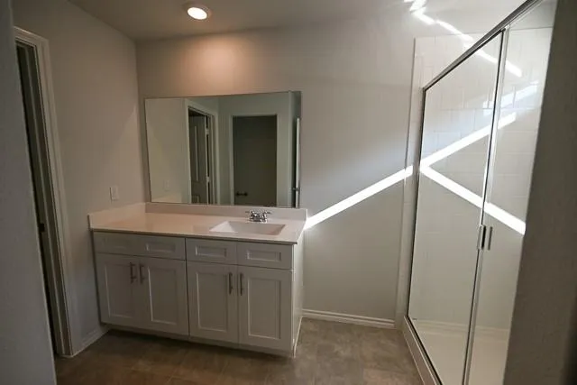 a bathroom with a double vanity sink and mirror