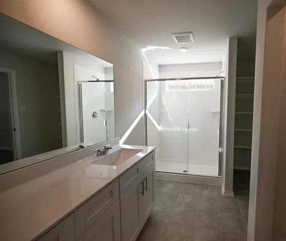 a bathroom with a double vanity sink and a mirror