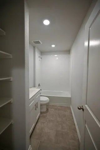 a bathroom with a toilet a sink and bathtub