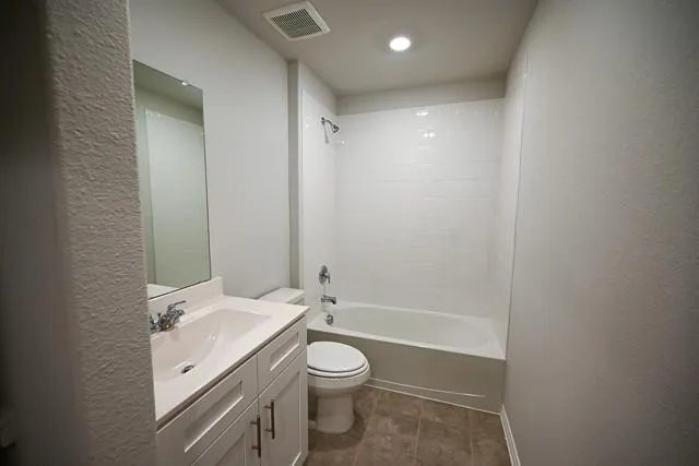 a bathroom with a granite countertop sink a toilet and shower
