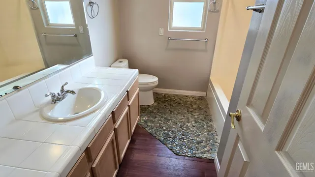 a kitchen with stainless steel appliances kitchen island granite countertop a refrigerator and a stove