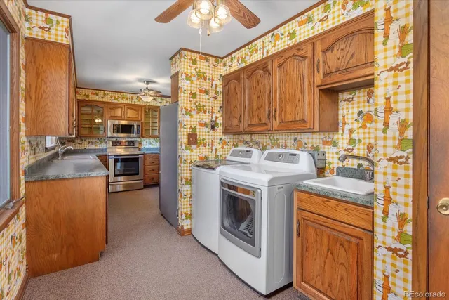 a view of an empty room with a fireplace and a window