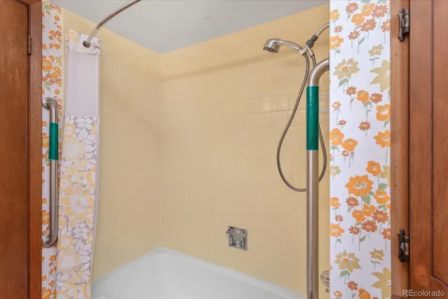 a bathroom with a shower curtain and a sink