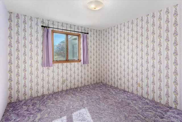 a view of a room with a wooden door