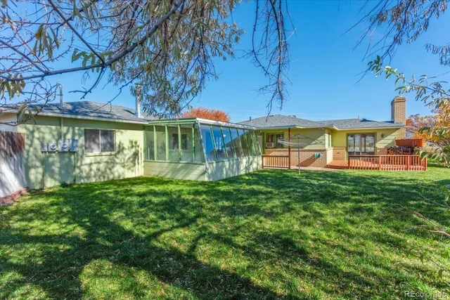a view of a roof deck with couches and wooden floor