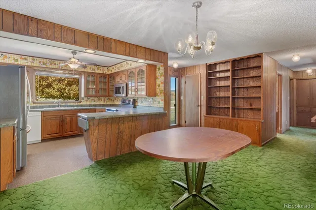 a view of kitchen with cabinets and window