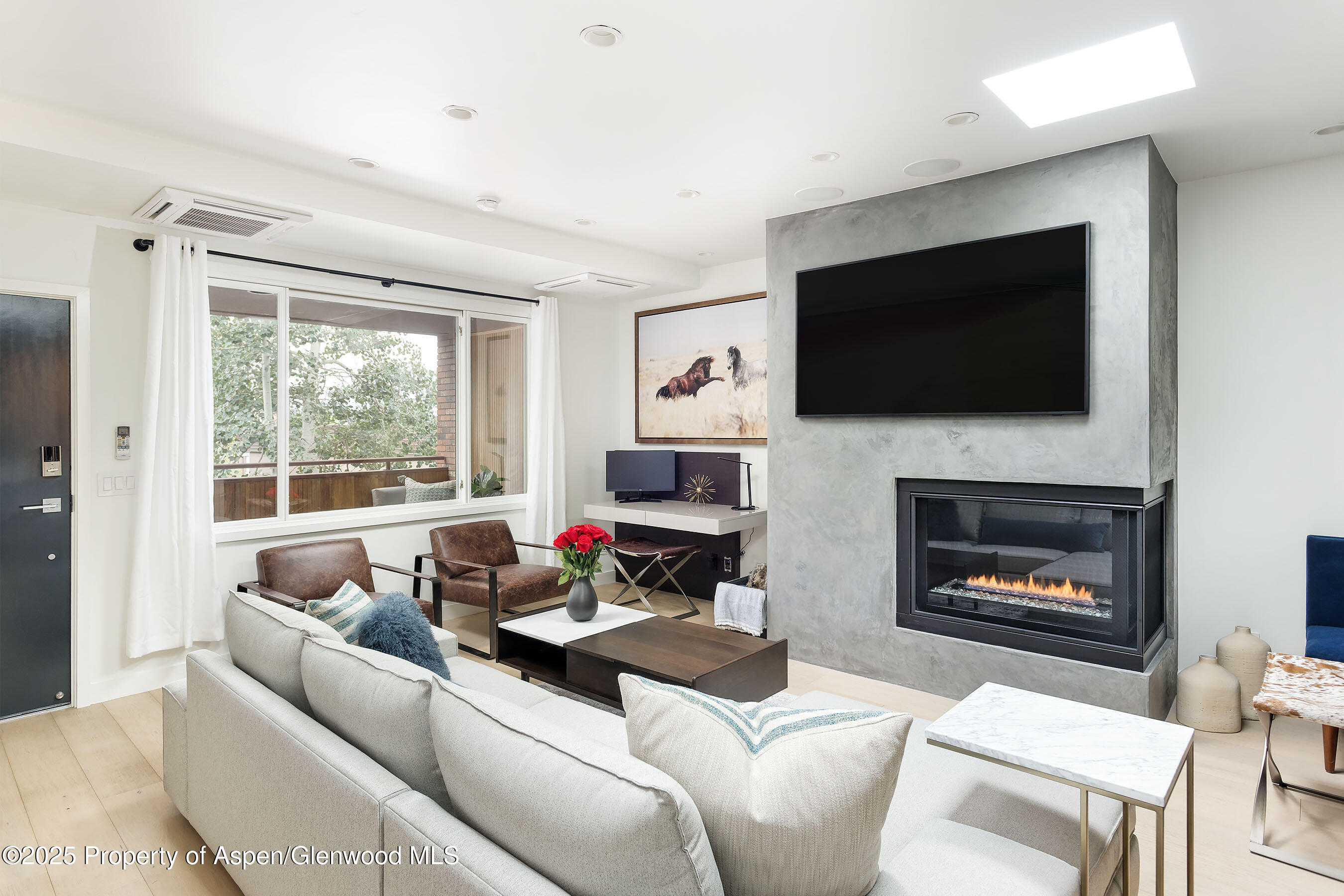 a living room with furniture a fireplace and a flat screen tv