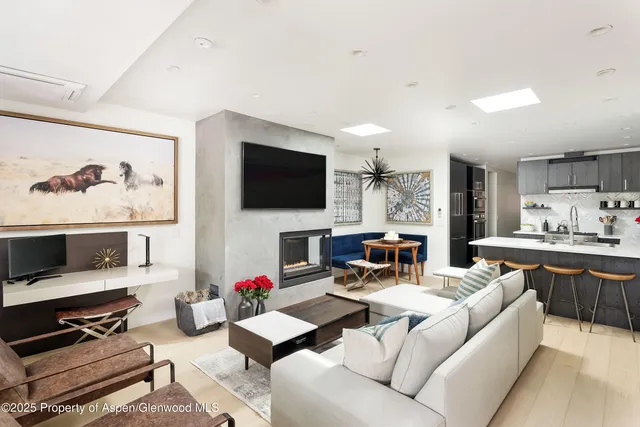 a living room with fireplace furniture and a flat screen tv
