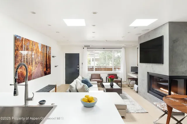 a living room with fireplace furniture and a flat screen tv