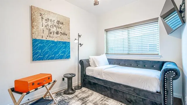 a bedroom with furniture and a window