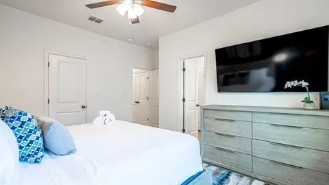 a bedroom with a bed and a flat screen tv