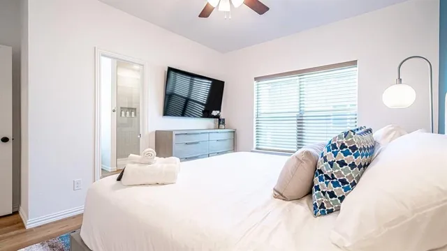 a bedroom with a bed and a chandelier