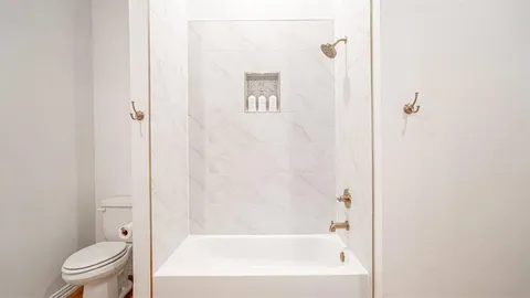 a bathroom with a bathtub and a toilet