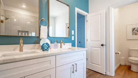 a bathroom with a sink a toilet and a mirror