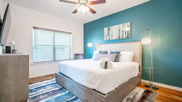 a bedroom with a bed and a chandelier