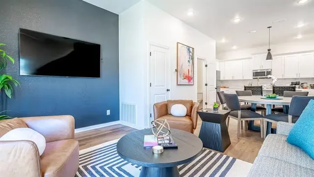 a living room with furniture and a flat screen tv