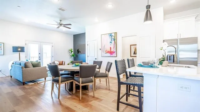 a view of a dining room with furniture and wooden floor