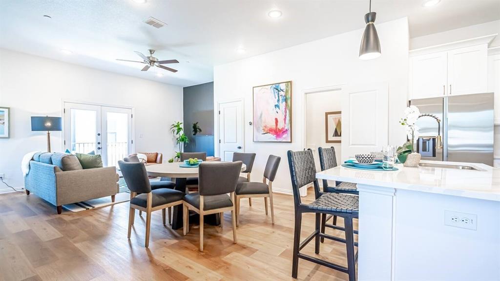 1215 Beaconsfield Lane, Unit 706 Arlington, TX 76011 - Photo 7 of 40 a view of a dining room with furniture and wooden floor