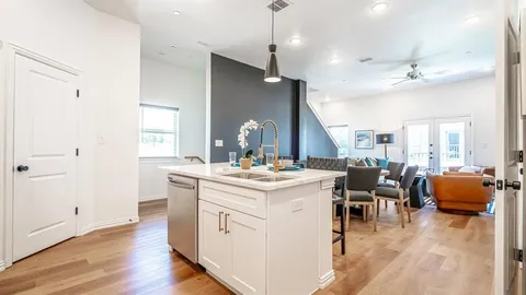 a view of kitchen with windows and wooden floors