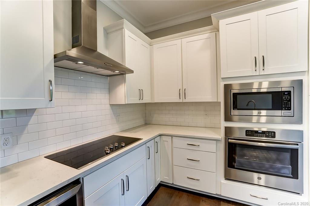 830 Providence Road, Unit 303 Charlotte, NC 28207 - Photo 11 of 39 a kitchen with white cabinets and appliances