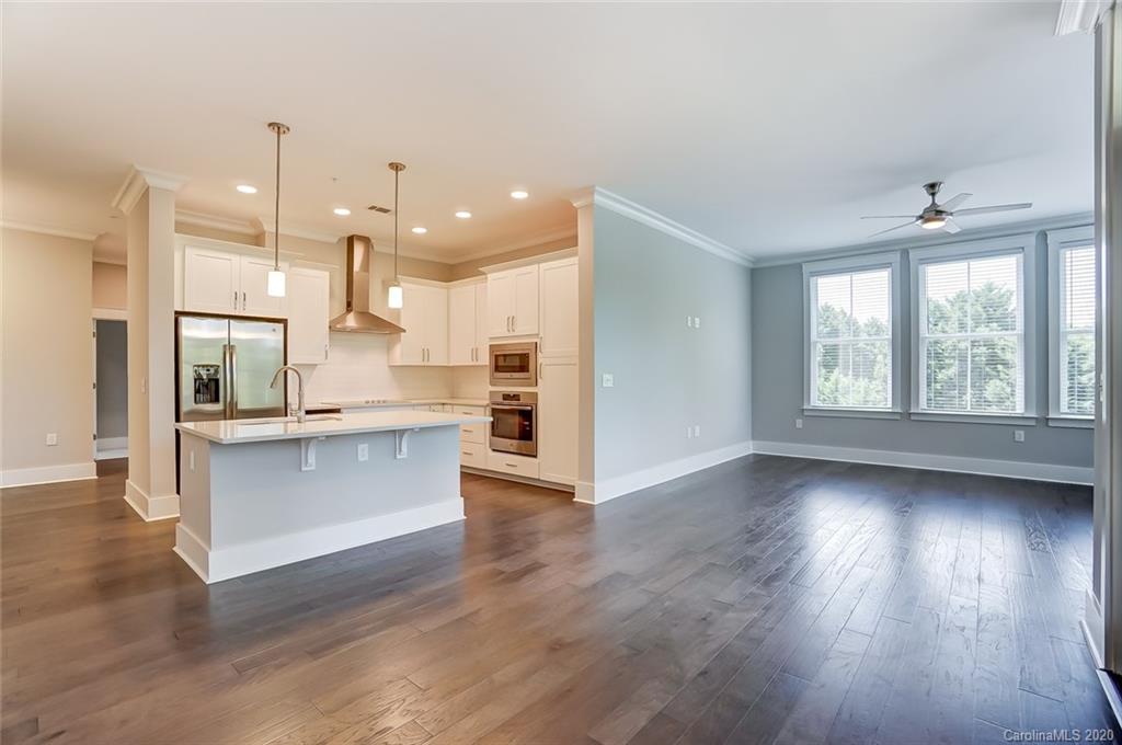 830 Providence Road, Unit 303 Charlotte, NC 28207 - Photo 16 of 39 a view of kitchen with wooden floor and electronic appliances
