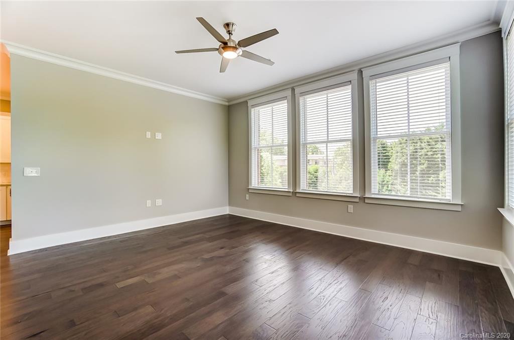 830 Providence Road, Unit 303 Charlotte, NC 28207 - Photo 20 of 39 an empty room with wooden floor and windows