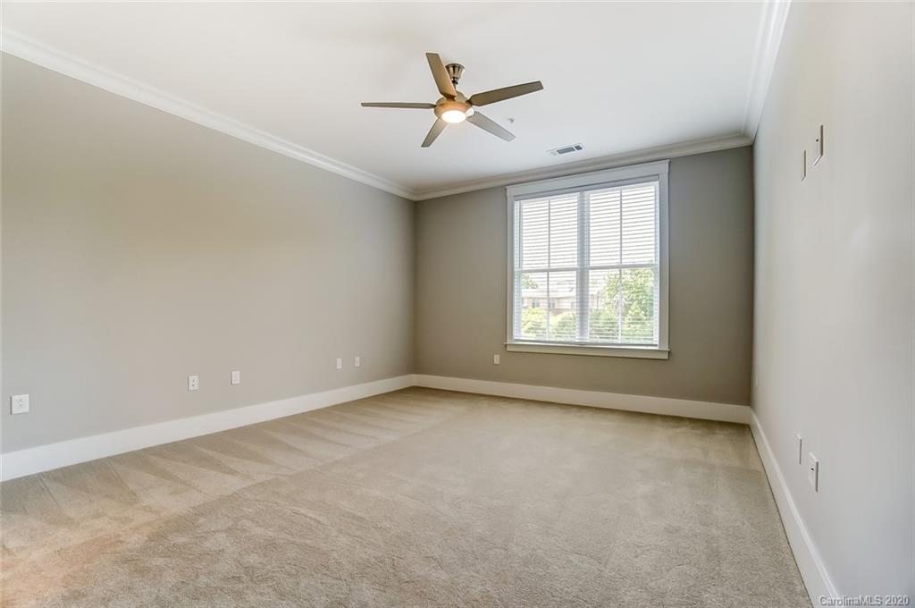 830 Providence Road, Unit 303 Charlotte, NC 28207 - Photo 21 of 39 an empty room with ceiling fan and windows