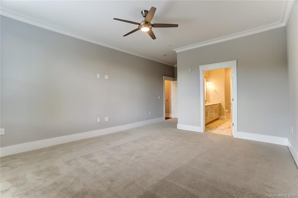830 Providence Road, Unit 303 Charlotte, NC 28207 - Photo 23 of 39 an empty room with a ceiling fan and a window