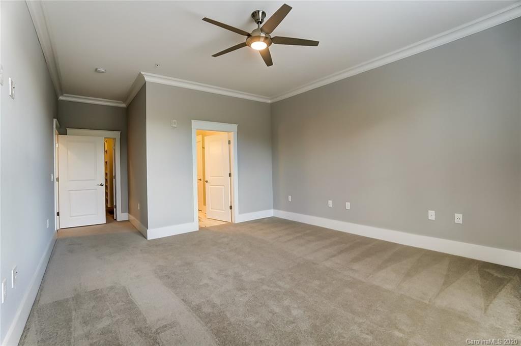 830 Providence Road, Unit 303 Charlotte, NC 28207 - Photo 24 of 39 a view of a livingroom with a ceiling fan & kitchen space