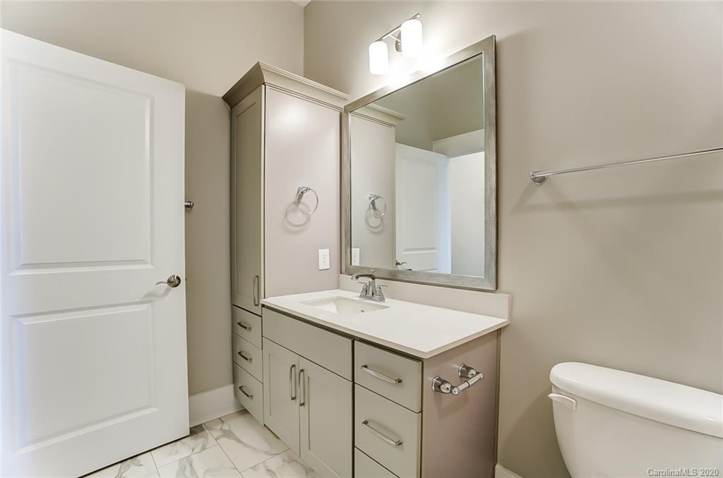830 Providence Road, Unit 303 Charlotte, NC 28207 - Photo 34 of 39 a bathroom with a sink a toilet and shower