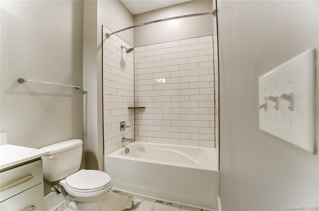 830 Providence Road, Unit 303 Charlotte, NC 28207 - Photo 35 of 39 a bathroom with a toilet and a bath tub