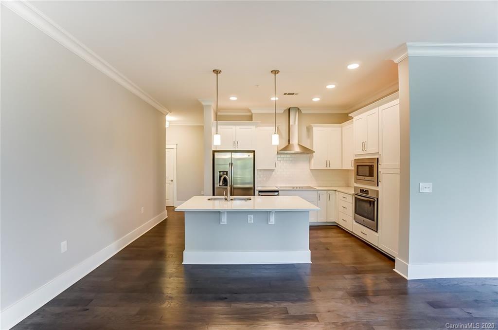 830 Providence Road, Unit 303 Charlotte, NC 28207 - Photo 6 of 39 a kitchen with stainless steel appliances granite countertop a stove a sink and a refrigerator