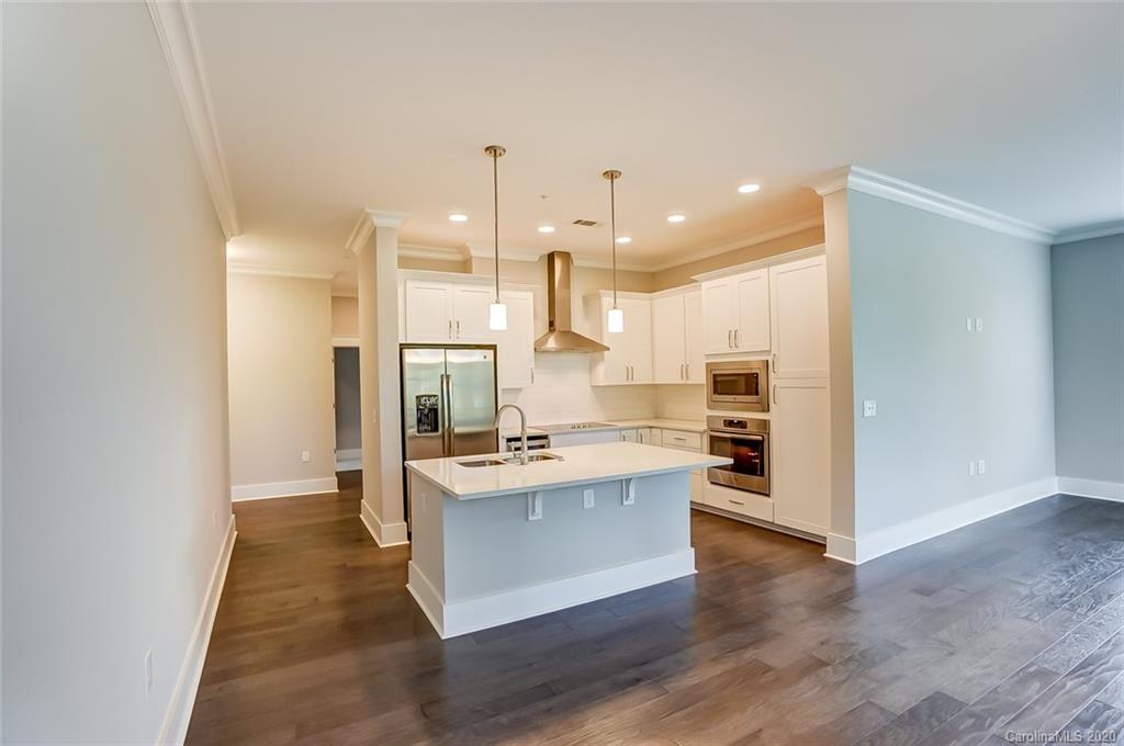 830 Providence Road, Unit 303 Charlotte, NC 28207 - Photo 7 of 39 a view of kitchen with kitchen island and stainless steel appliances